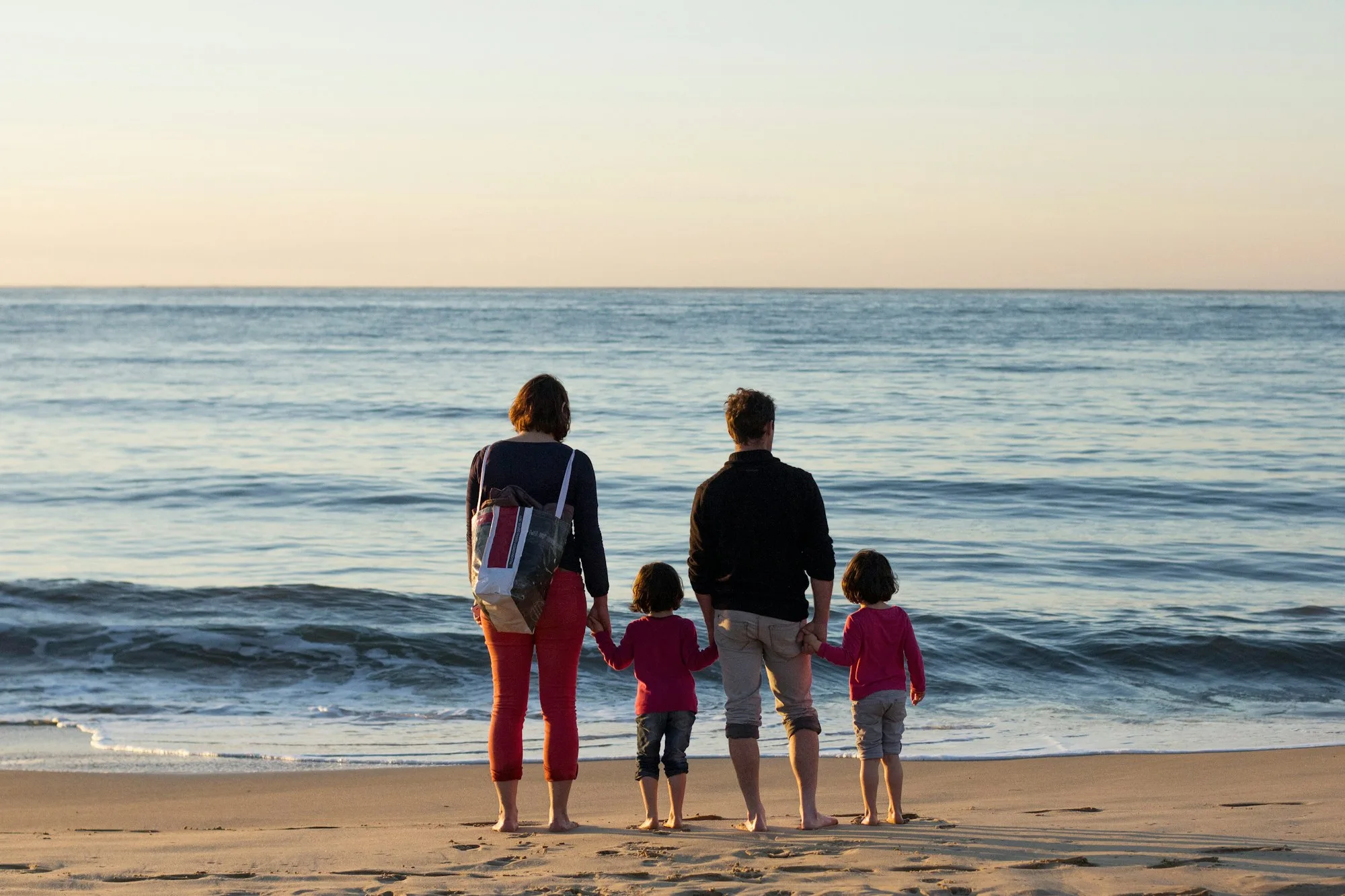 Family walking together along the beach